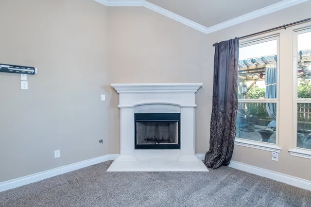 a living room with a fireplace and a large window