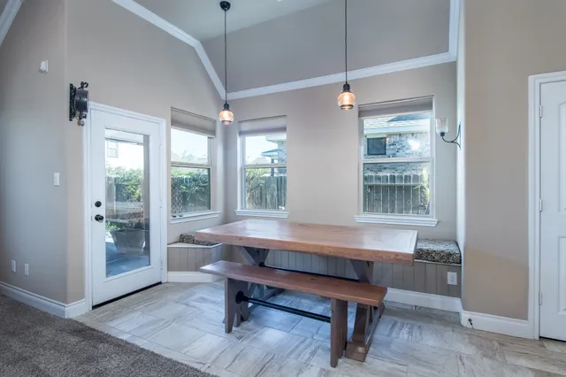 a room with pool table and windows