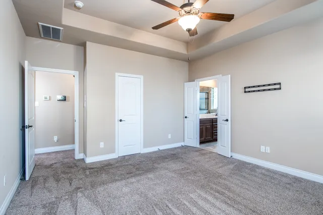 wooden floor in an empty room and a ceiling fan