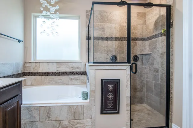 a bathroom with a bathtub and shower