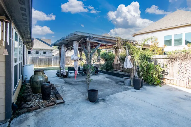 a view of a porch with furniture and a yard
