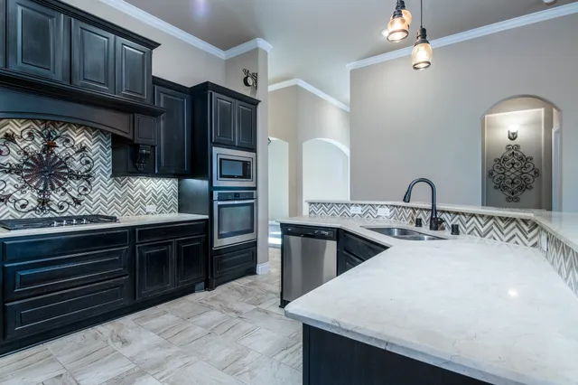a kitchen with stainless steel appliances granite countertop a sink and stove