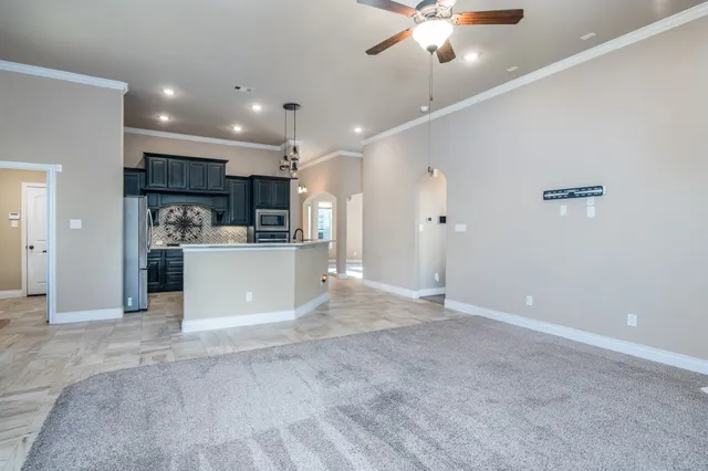 a view of a kitchen with a sink and a refrigerator