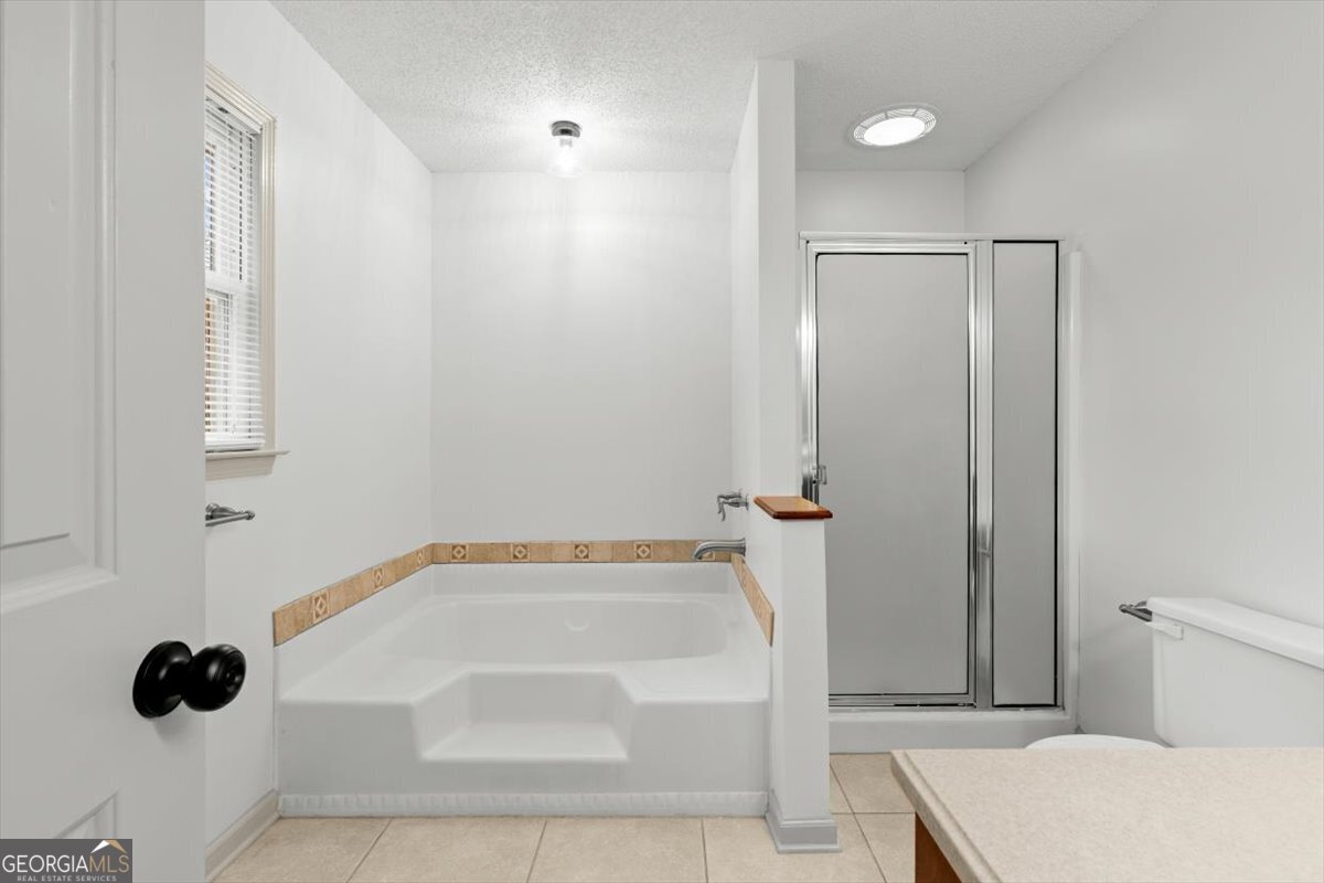 325 Almon Road Carrollton, GA 30117 - Photo 15 of 41 a bathroom with a bathtub and a shower