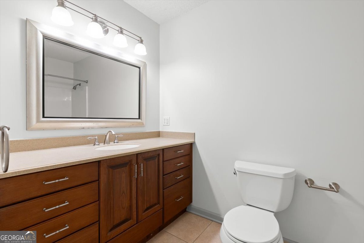 325 Almon Road Carrollton, GA 30117 - Photo 18 of 41 a bathroom with a toilet sink and mirror