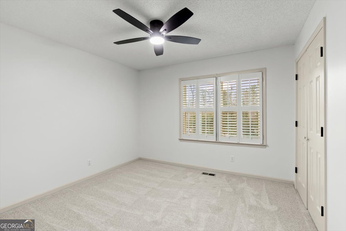 325 Almon Road Carrollton, GA 30117 - Photo 20 of 41 an empty room with a window and a ceiling fan