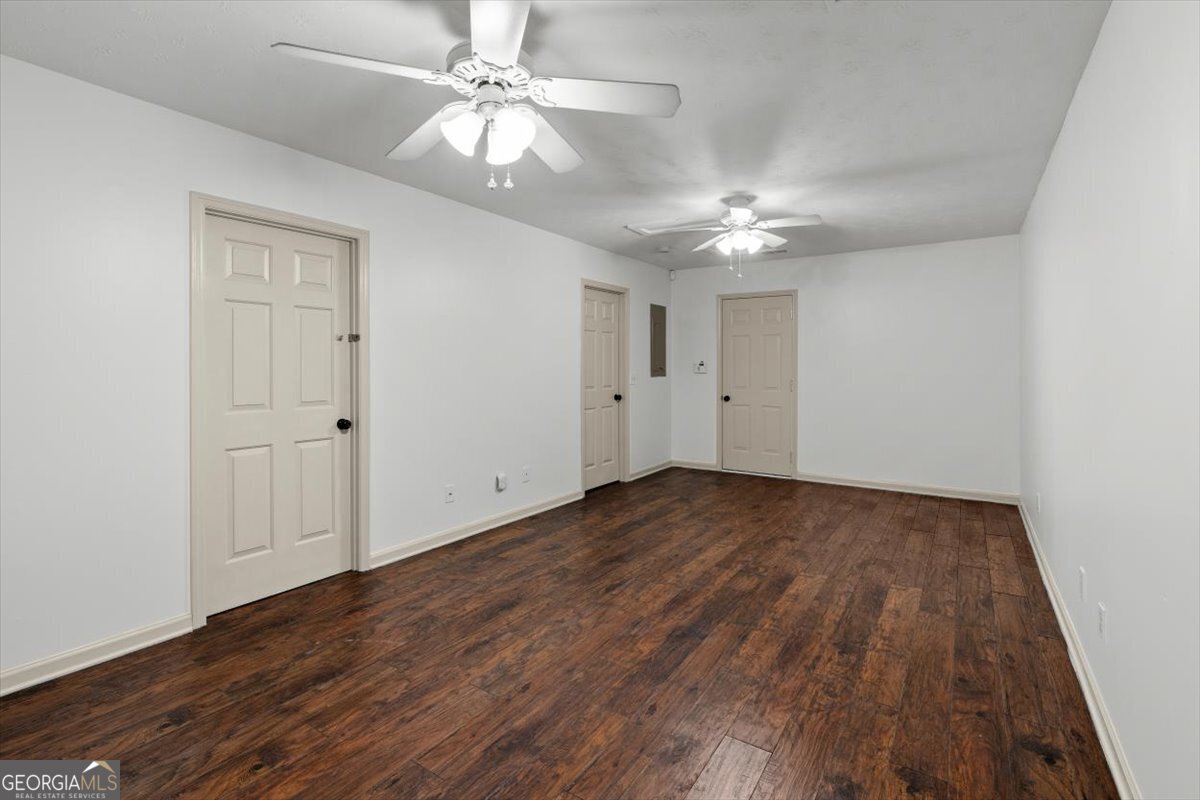 325 Almon Road Carrollton, GA 30117 - Photo 21 of 41 an empty room with wooden floor ceiling fan and windows