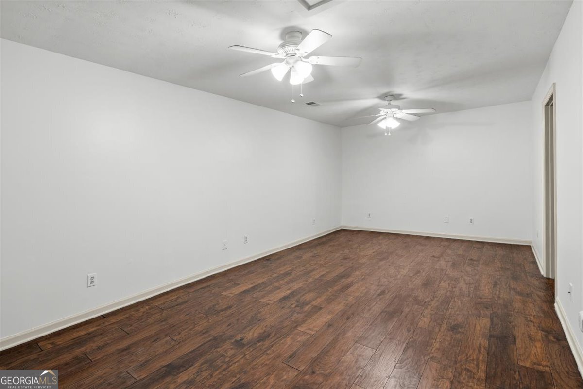 325 Almon Road Carrollton, GA 30117 - Photo 22 of 41 a view of a room with wooden floor and a ceiling fan