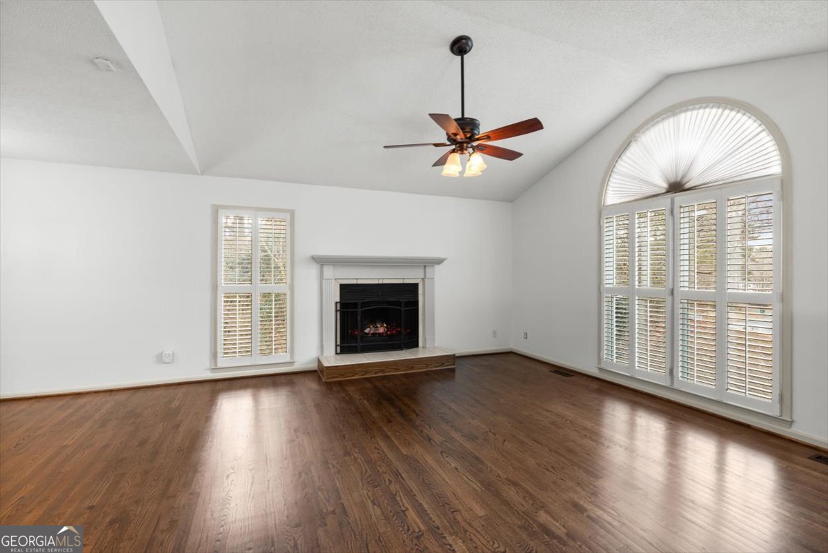 325 Almon Road Carrollton, GA 30117 - Photo 4 of 41 an empty room with wooden floor fan and windows