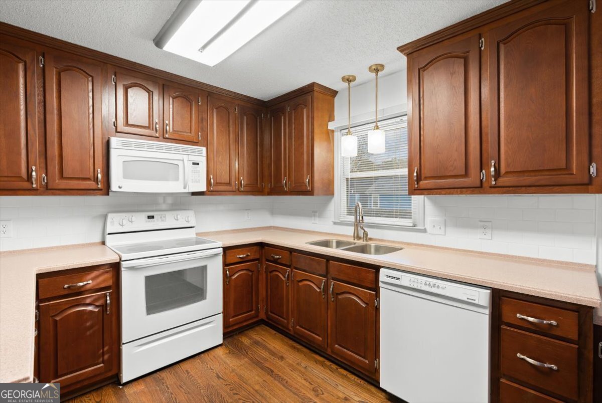 325 Almon Road Carrollton, GA 30117 - Photo 8 of 41 a kitchen with a sink stove and cabinets