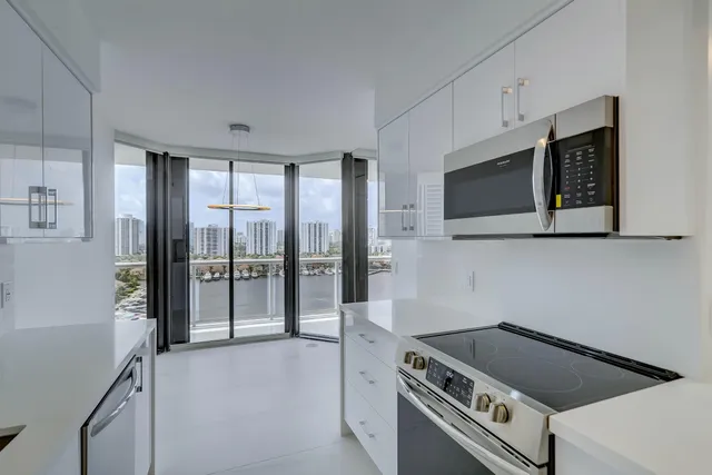 a kitchen with stainless steel appliances granite countertop a stove a microwave and a refrigerator