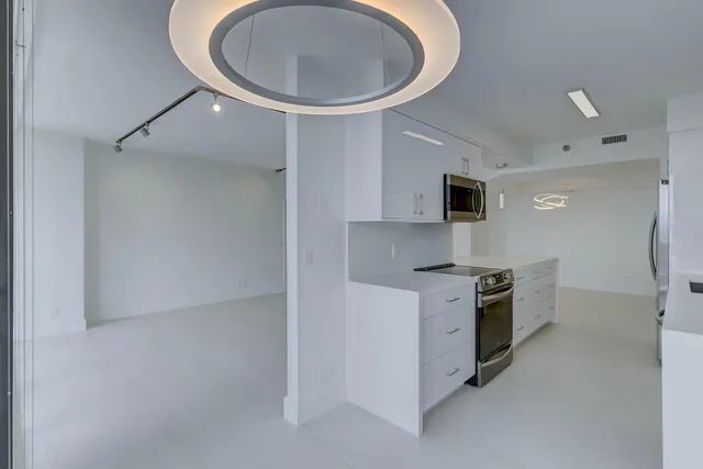 a kitchen with a stove top oven and sink