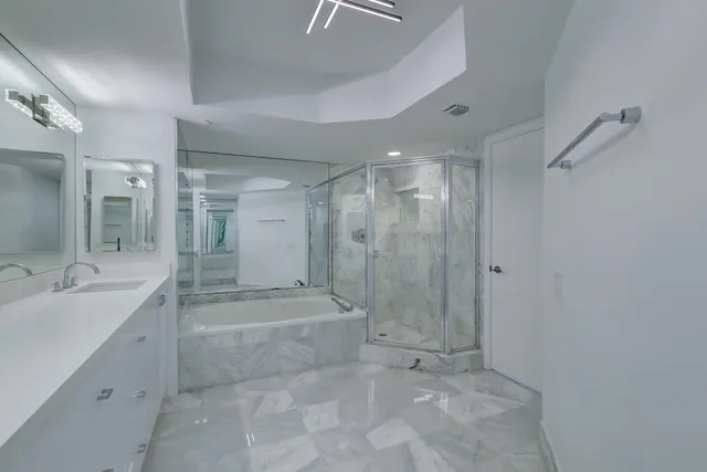 a bathroom with a glass shower door