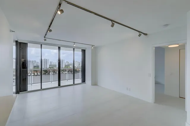 a view of an empty room with windows