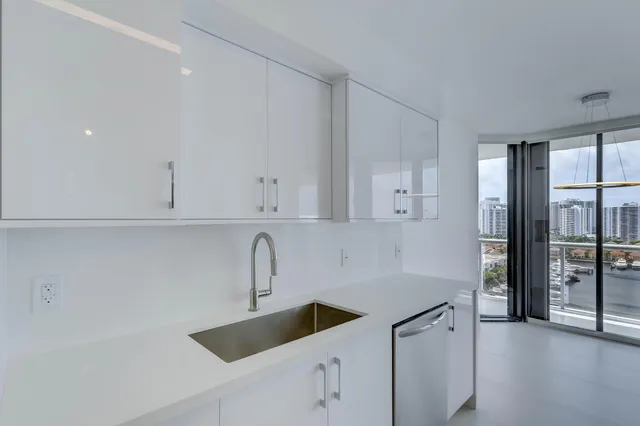 a kitchen with a refrigerator sink and cabinets