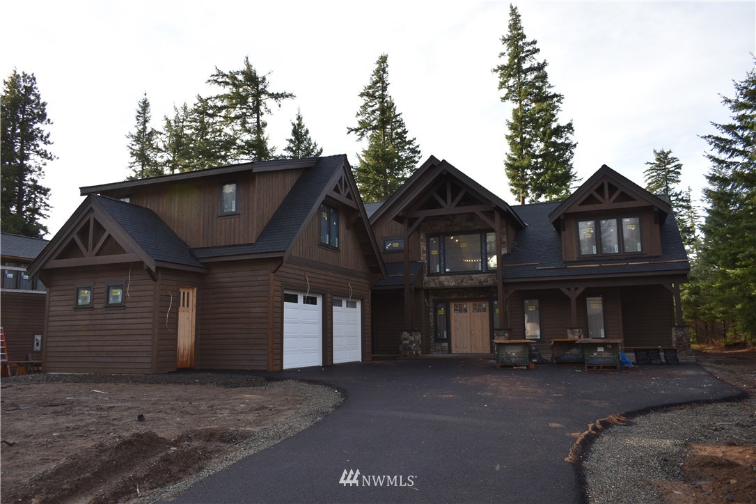 1421 Kokanee Loop Cle Elum, WA 98922 - Photo 2 of 33 a front view of a house with a garden