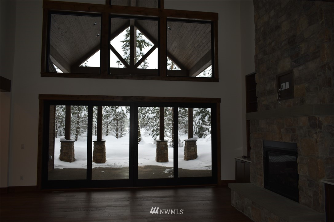1421 Kokanee Loop Cle Elum, WA 98922 - Photo 6 of 33 a view of empty room with wooden floor and floor to ceiling window