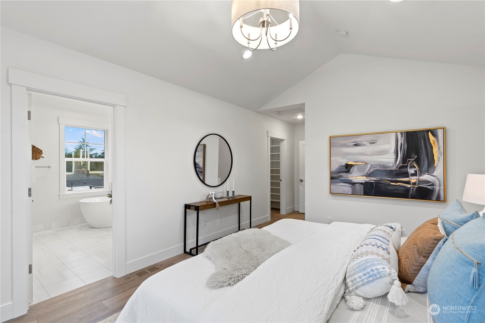 10063 Dibble Avenue Northwest Seattle, WA 98177 - Photo 23 of 35 a bedroom with a bed a table and chair