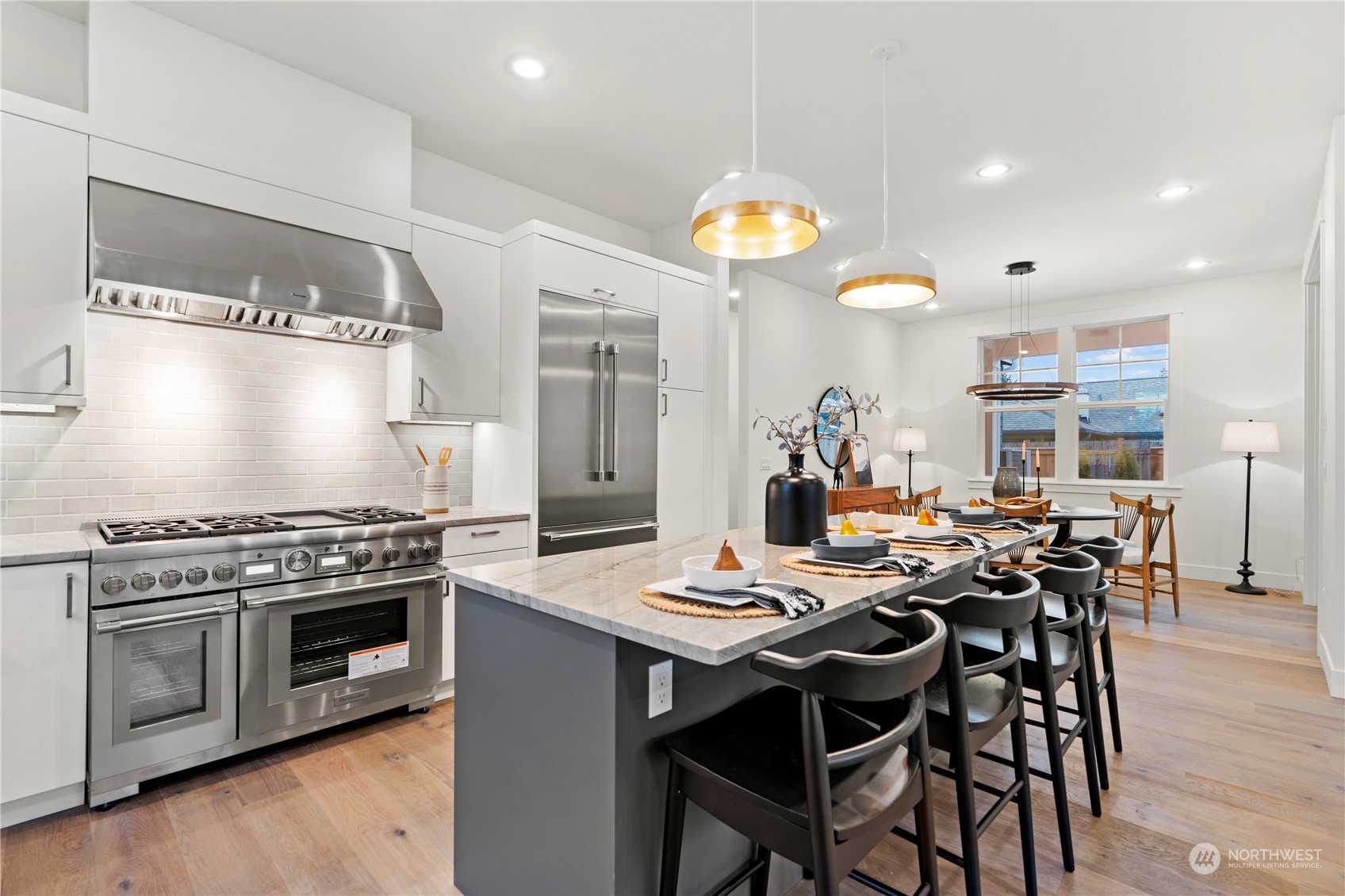 10063 Dibble Avenue Northwest Seattle, WA 98177 - Photo 6 of 35 a kitchen with a stove a table and chairs in it