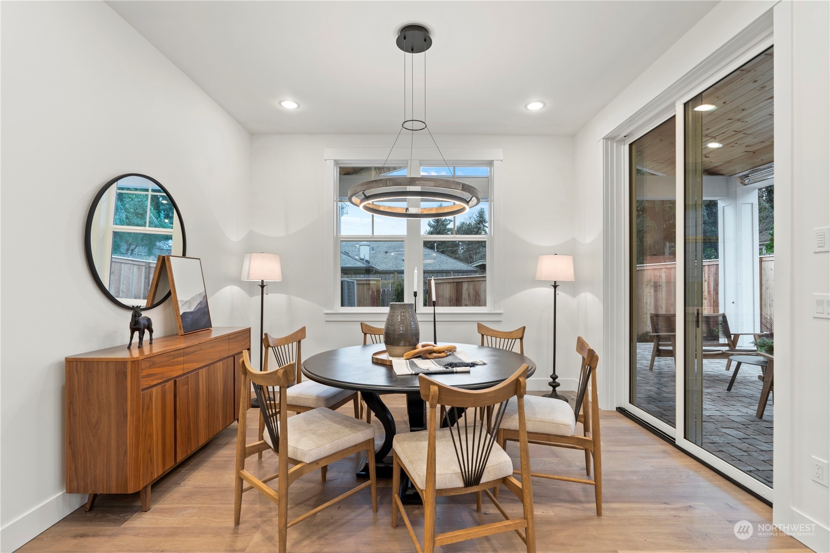 10063 Dibble Avenue Northwest Seattle, WA 98177 - Photo 9 of 35 a dining room with furniture a chandelier and wooden floor
