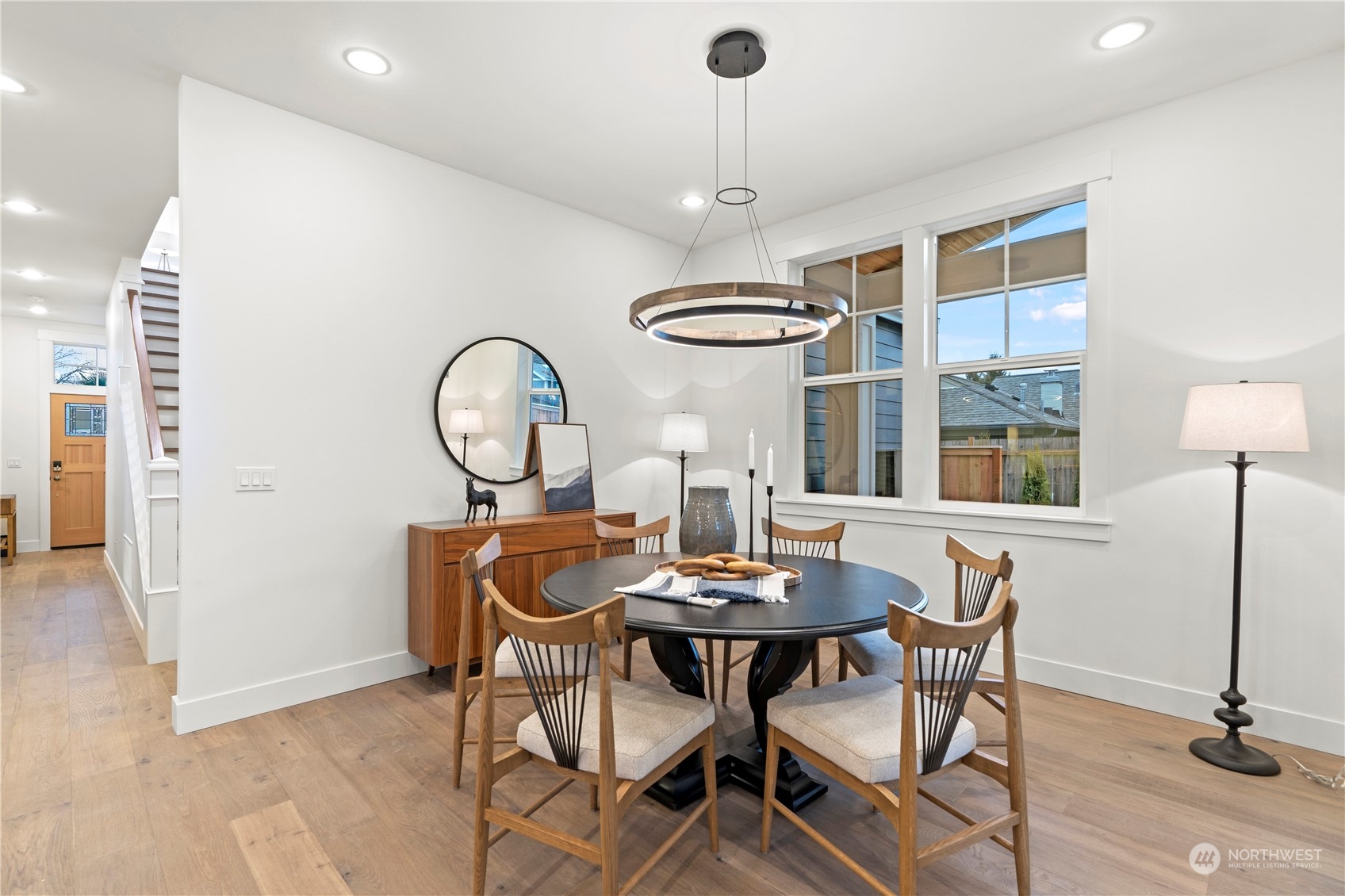 10063 Dibble Avenue Northwest Seattle, WA 98177 - Photo 10 of 35 a view of a dining room with furniture a chandelier and wooden floor
