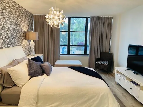 a living room with a bed and a window