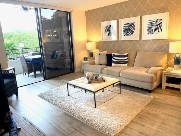 a living room with furniture and a floor to ceiling window