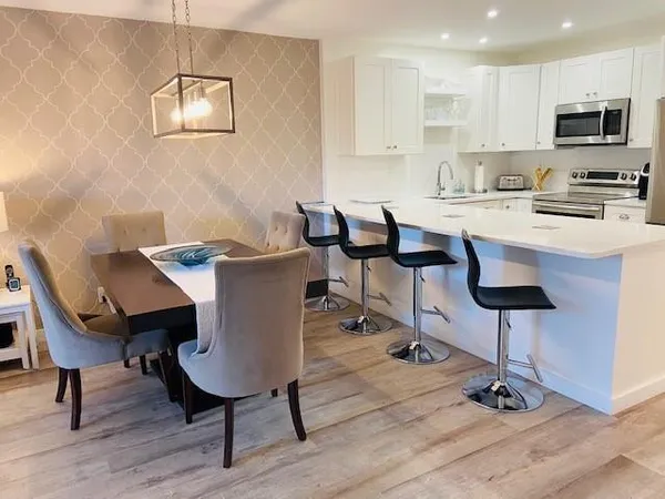 a view of a dining room with furniture and wooden floor