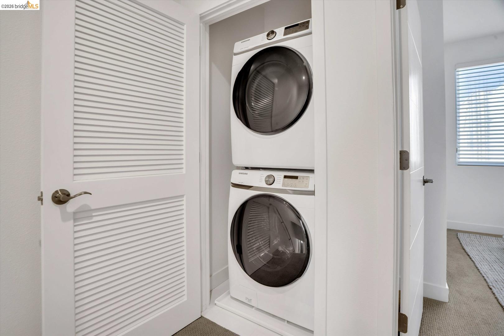 2229 Myrtle Street Oakland, CA 94607 - Photo 24 of 37 laundry area with carpet floors and stacked washer and clothes dryer