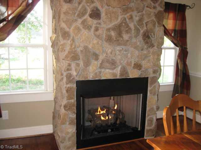 7677 Zion Church Road Staley, NC 27355 - Photo 3 of 10 Dining Room. Custom hand laid rock fireplace including remote controlled gas logs w/blower in Dining Room.