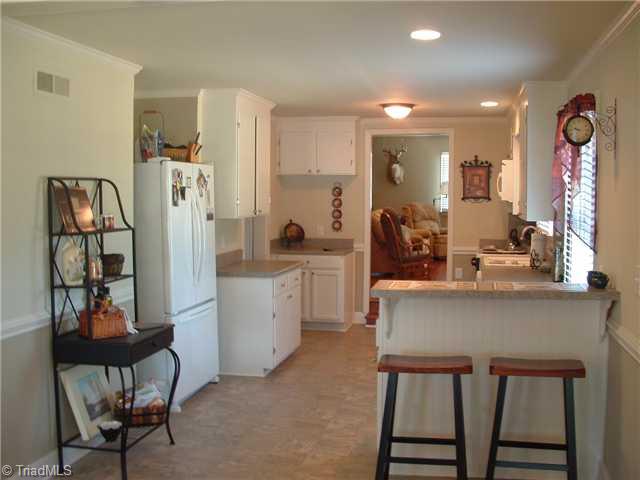 7677 Zion Church Road Staley, NC 27355 - Photo 5 of 10 Kitchen. Spacious Kitchen, angle 2 ,with eat at bar and recessed fridge.