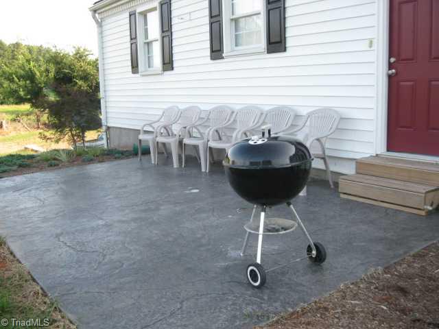 7677 Zion Church Road Staley, NC 27355 - Photo 10 of 10 Exterior Back. Grill out on the custom stamped concrete patio.