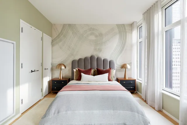 a bedroom with a bed and a large window