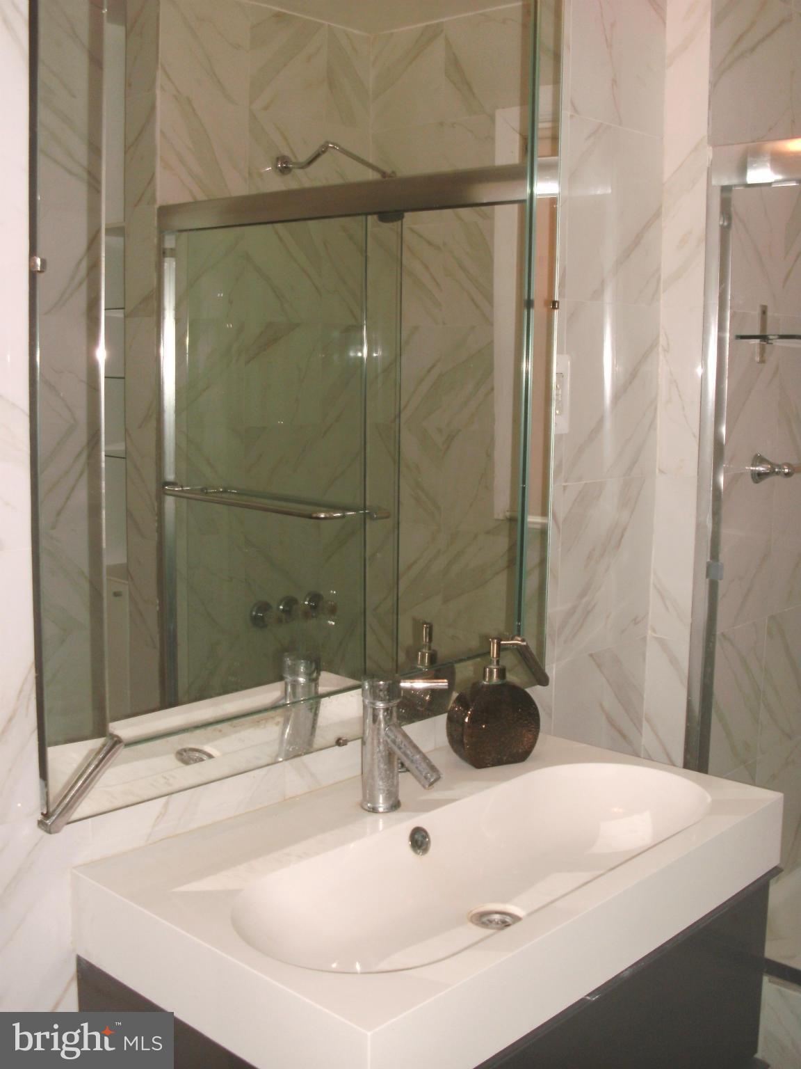8801 Littlewood Road Baltimore, MD 21234 - Photo 11 of 17 a bathroom with a sink and a mirror