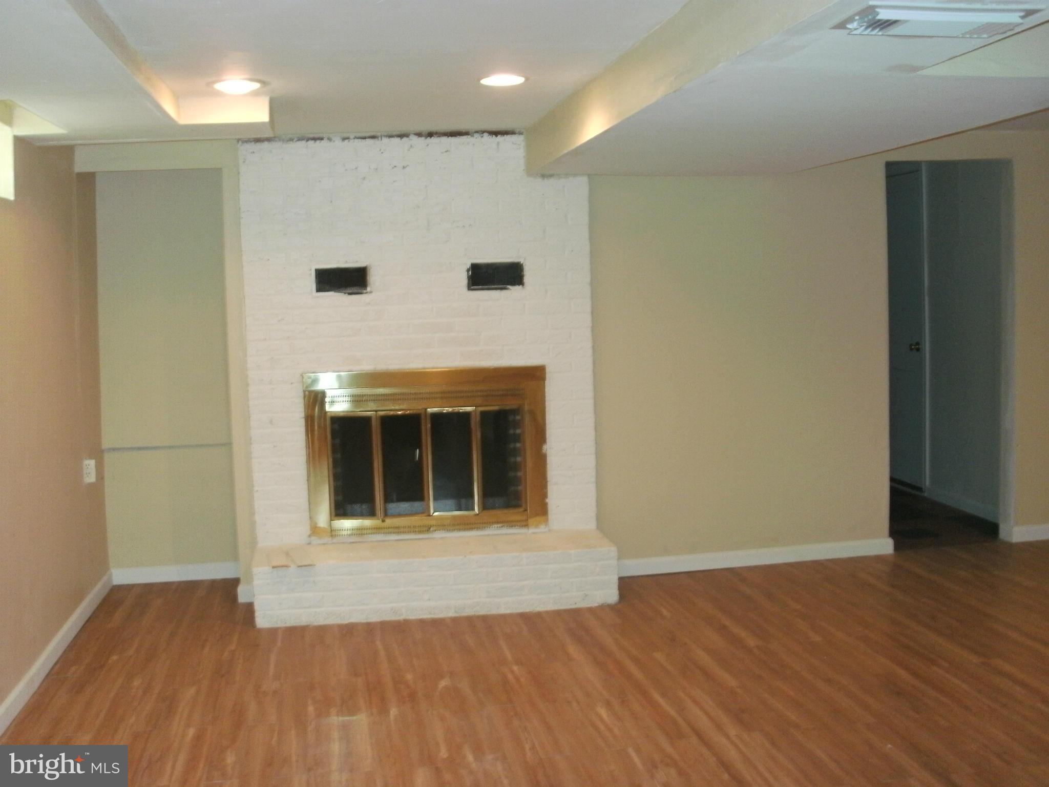 8801 Littlewood Road Baltimore, MD 21234 - Photo 12 of 17 a view of an empty room with wooden floor and a window