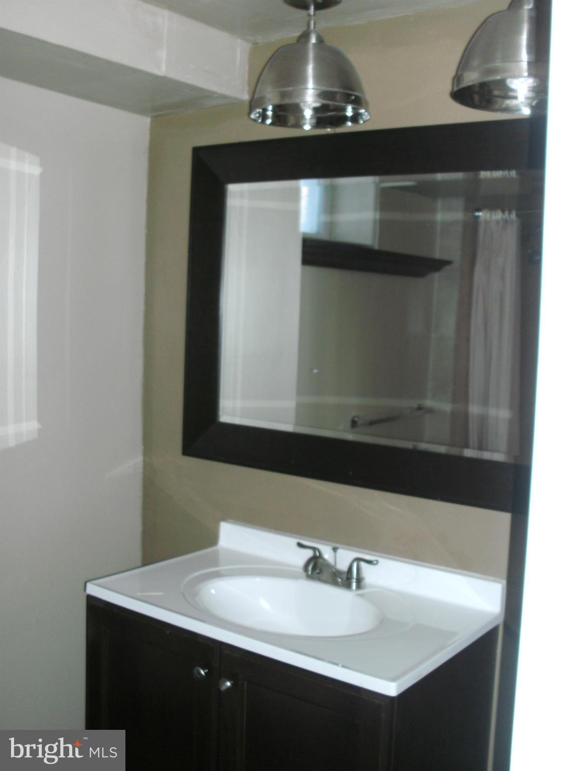 8801 Littlewood Road Baltimore, MD 21234 - Photo 14 of 17 a bathroom with a sink and a mirror