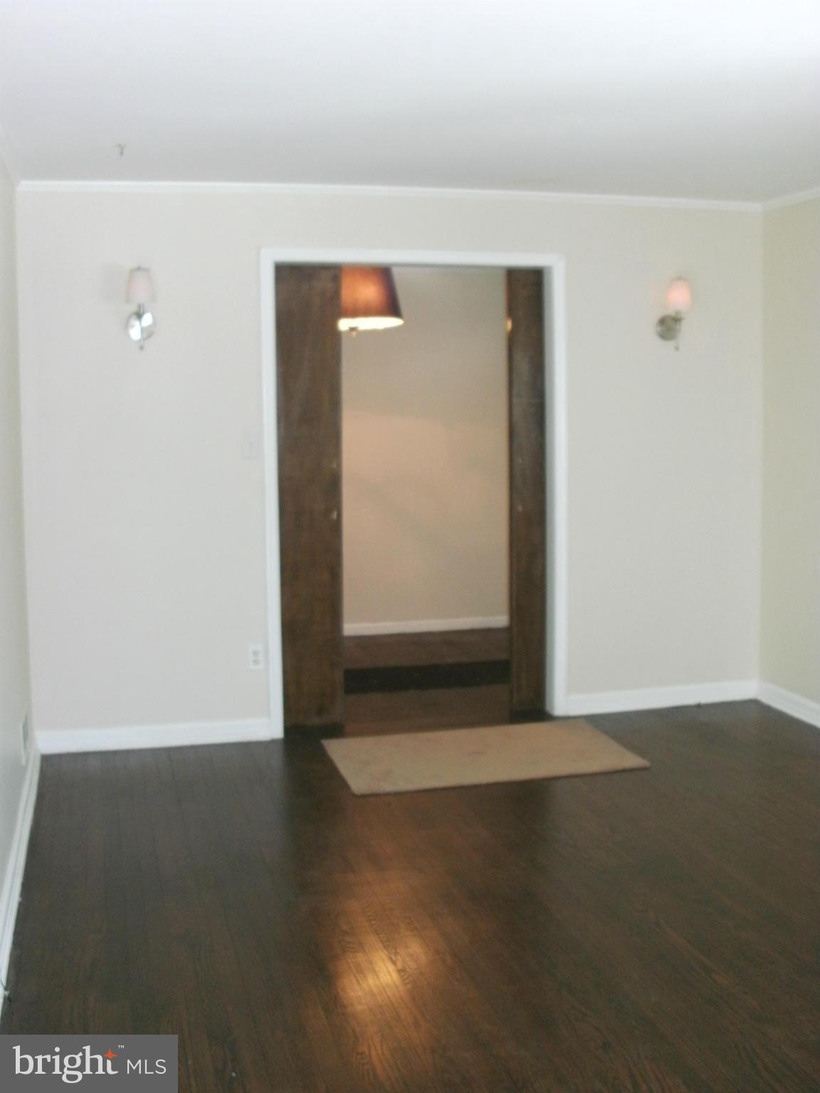 8801 Littlewood Road Baltimore, MD 21234 - Photo 5 of 17 a view of an empty room with wooden floor