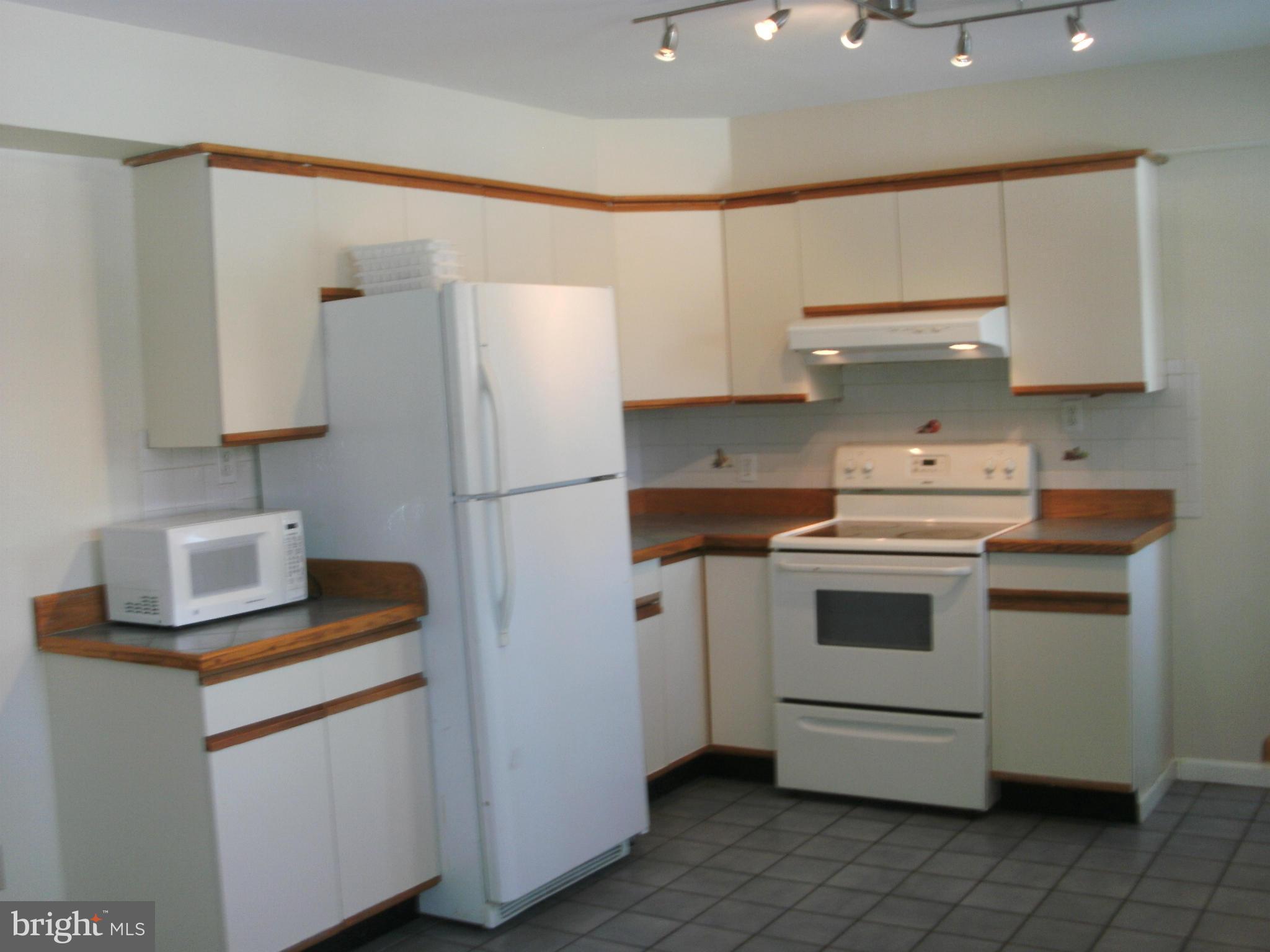 8801 Littlewood Road Baltimore, MD 21234 - Photo 7 of 17 a kitchen with a stove cabinets and refrigerator