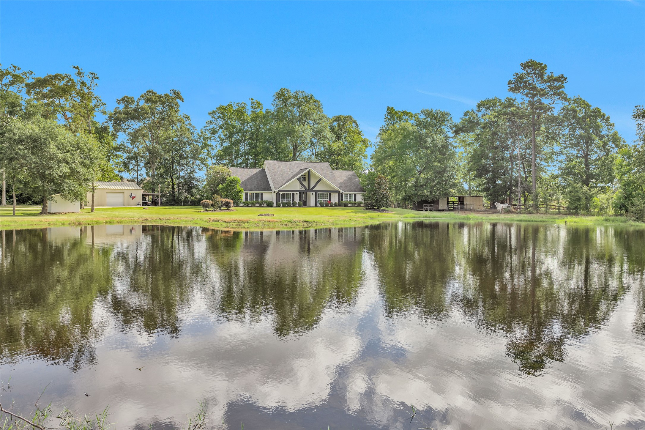 10810 Farrell Road Willis, TX 77378 - Photo 2 of 36 a view of a lake with a building in the background