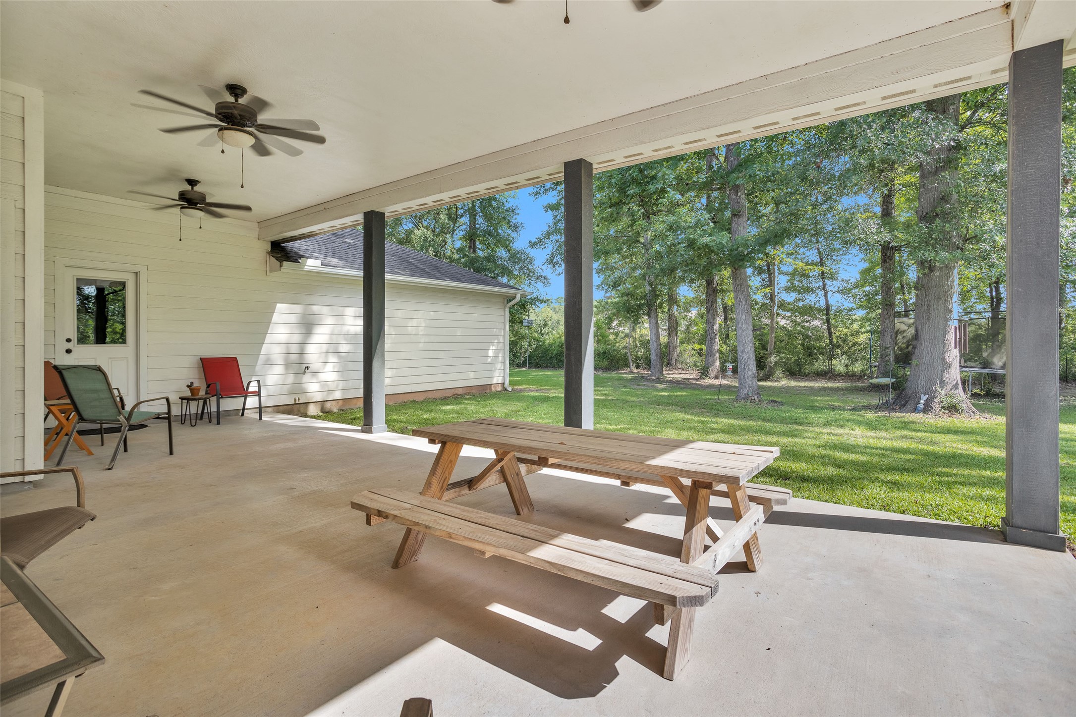 10810 Farrell Road Willis, TX 77378 - Photo 28 of 36 a living room with patio furniture and a garden