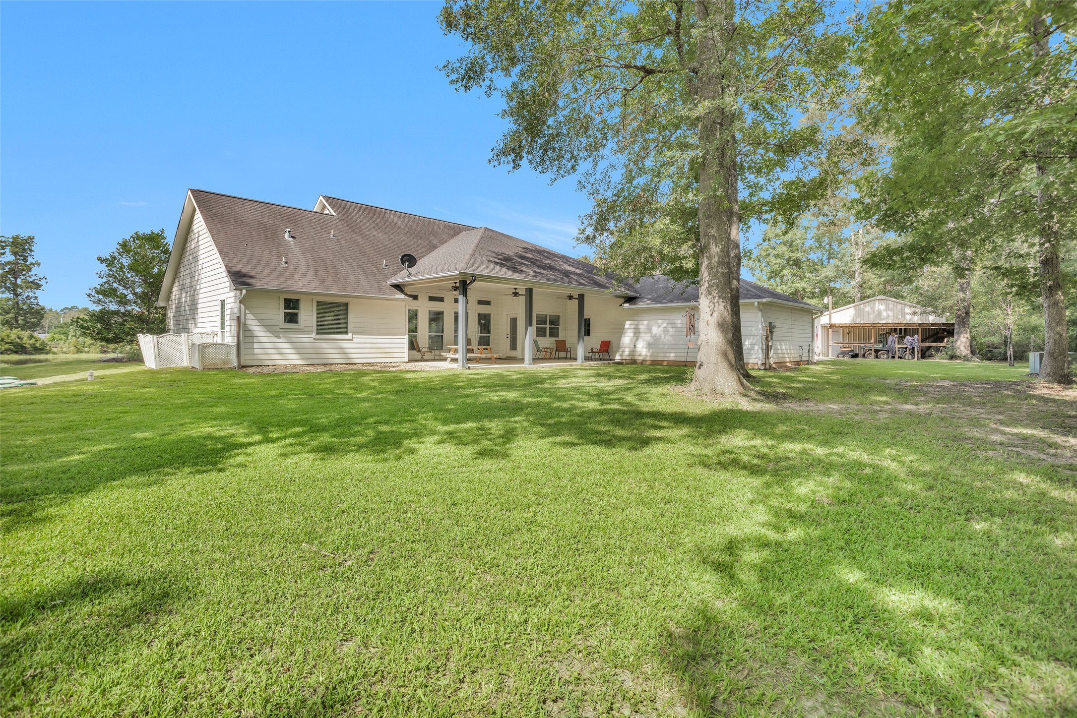 10810 Farrell Road Willis, TX 77378 - Photo 30 of 36 a front view of a house with a garden and trees