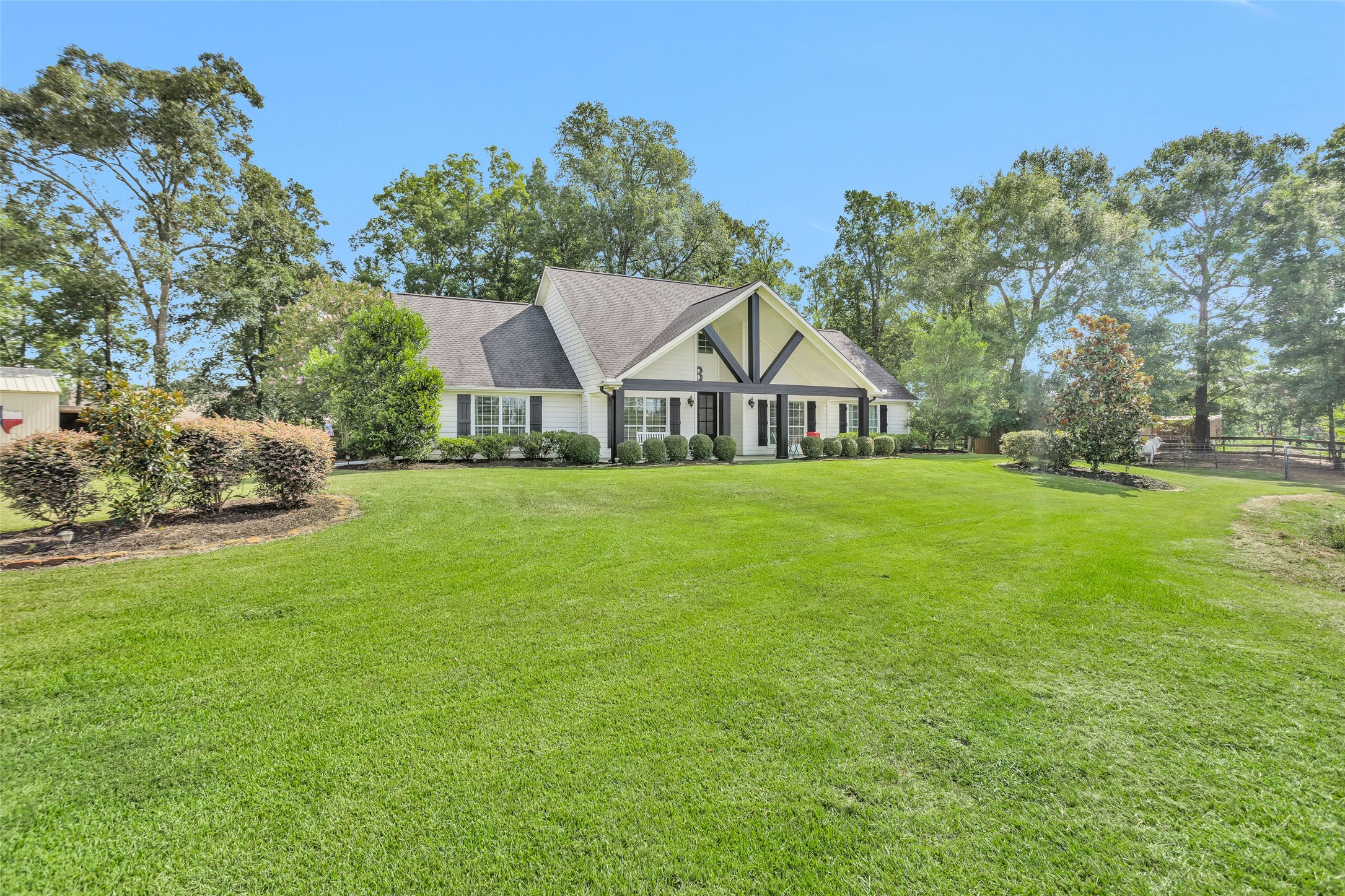 10810 Farrell Road Willis, TX 77378 - Photo 3 of 36 a white house with a big yard and large trees