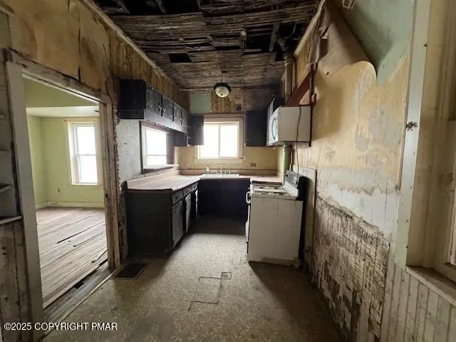 a kitchen with a refrigerator and a sink