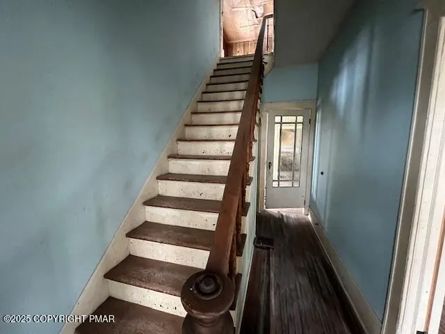 a view of entryway and gallery with wooden floor