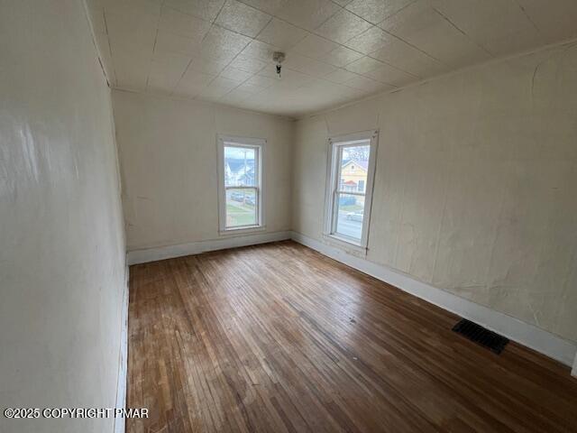 114 North Higgins Avenue Sayre, PA 18840 - Photo 19 of 21 an empty room with wooden floor and windows