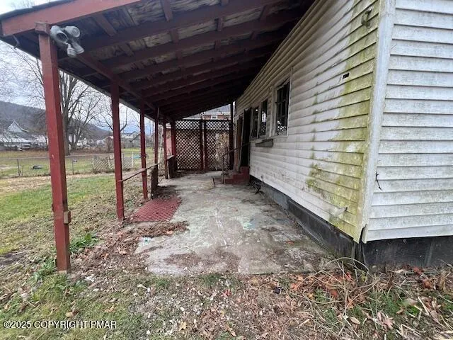 a view of a backyard with wooden fence and floor