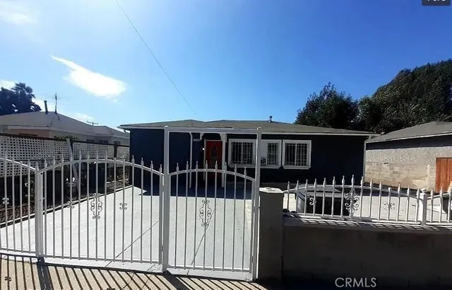 a view of a house with a yard and potted plants