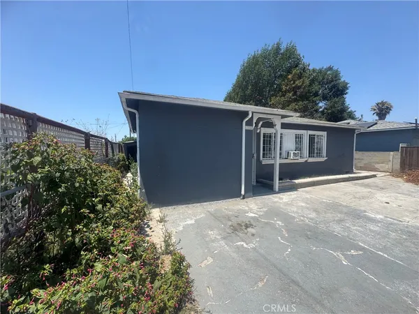 a kitchen with stainless steel appliances granite countertop a refrigerator a sink dishwasher a stove and white countertops with wooden floor