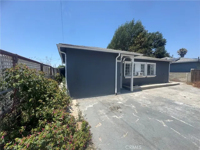 a kitchen with stainless steel appliances granite countertop a refrigerator a sink dishwasher a stove and white countertops with wooden floor