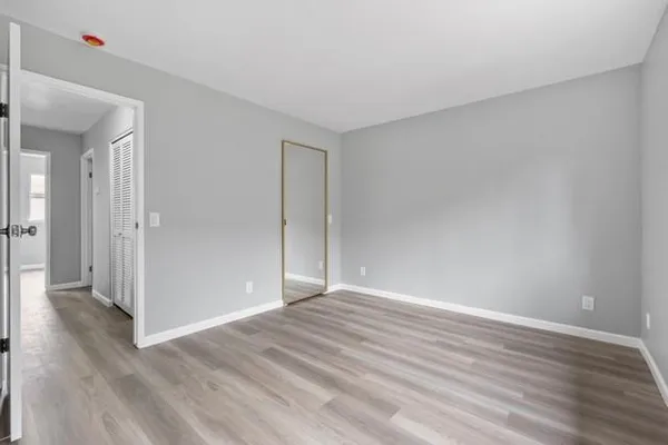 a view of an empty room and wooden floor